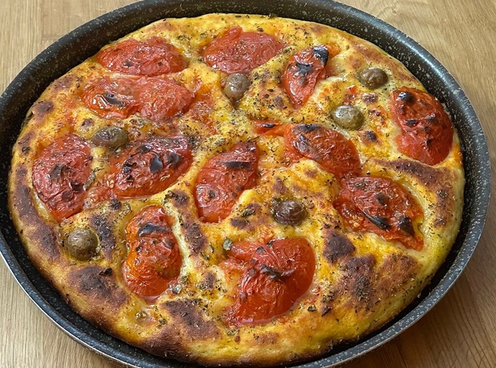 Hands-on Bari class making authentic tomato-topped Focaccia Barese Preparing Focaccia Barese, soft tomato-topped bread, in a Bari cooking class
