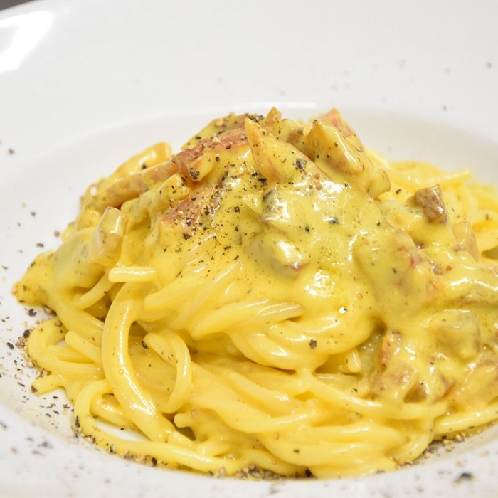 Classic Carbonara Pasta A plate of creamy carbonara pasta topped with crispy guanciale
