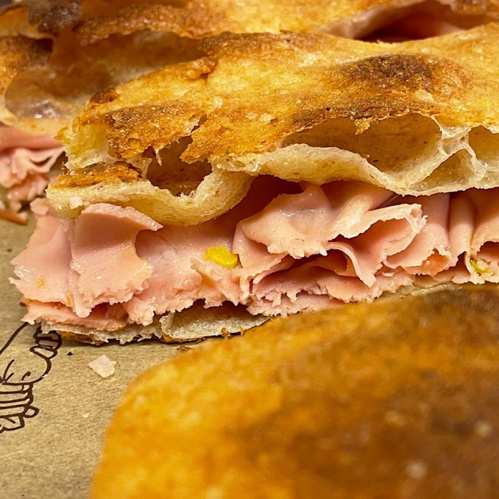 Crunchy pizza bianca flatbread stuffed with aromatic mortadella