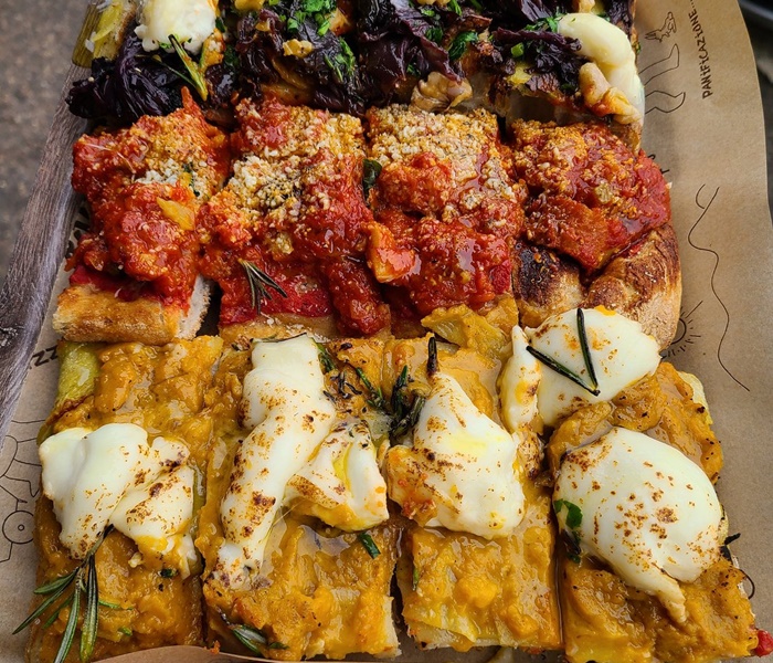 Bonci pizza al taglio â A flavourful highlight of your Rome food tour at Trionfale Market Richly topped Bonci pizza al taglio with fresh ingredients, tasted during a Rome food tour at Trionfale Market
