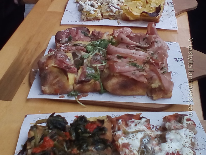 Pizza al taglio slice topped with mortadella and potato from a Rome food tour