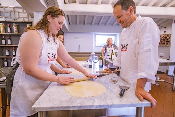 Fresh Pasta Making Class in Florence with Ciao Foodies Guests rolling fresh pasta dough during Ciao Foodies cooking class in Florence, Italy