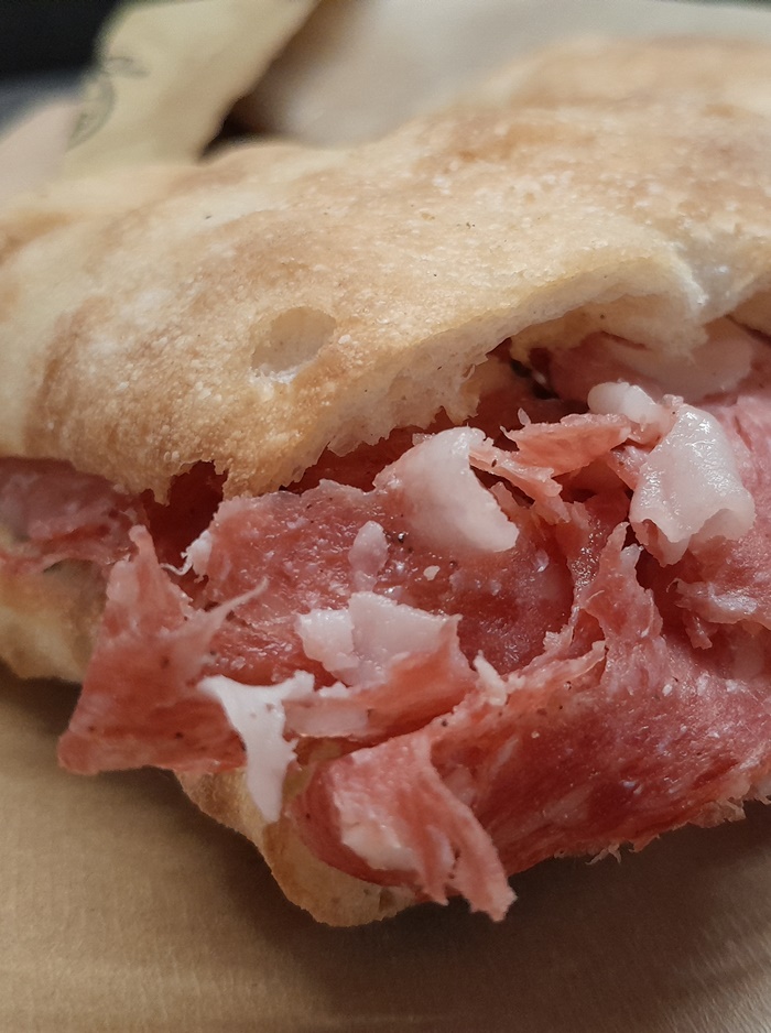 Salami schiacciata sandwich in Florence, traditional Tuscan street food