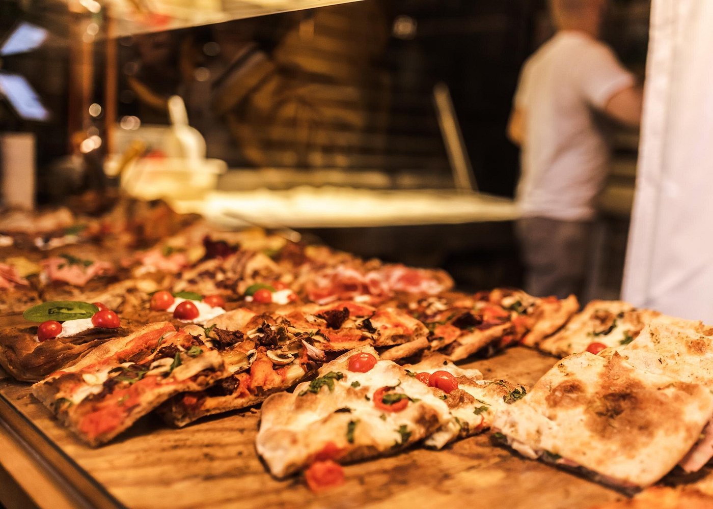Discover a variety of freshly baked bread, focaccia, and pizza at bakeries in Bologna Freshly baked bread, focaccia, and pizza from a bakery in Bologna