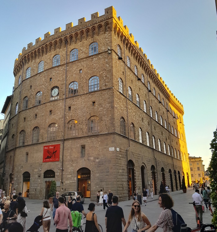 Piazza Santa Trinita in Florence, filled with people enjoying the square