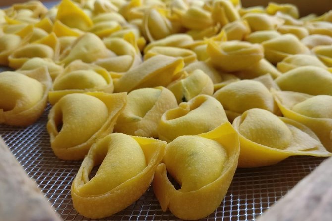 Traditional Sfogline Making Tortellini on a Bologna Food Tour Handmade tortellini being shaped by traditional sfogline during our Bologna food tour experience