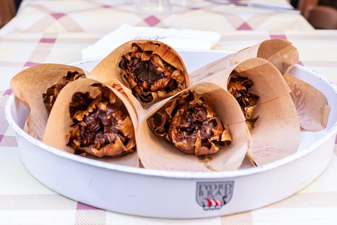 Crispy golden carciofi alla giudia (Jewish-style fried artichokes) served during the Eternal Rome Food Tour in the Jewish Ghetto of Rome.