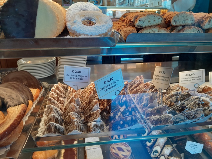 Panforte: Classic Florentine Nut and Fruit Cake at a Local Pasticceria Traditional panforte cake on display at a Florence pasticceria, showcasing the rich blend of nuts, dried fruits, and honey