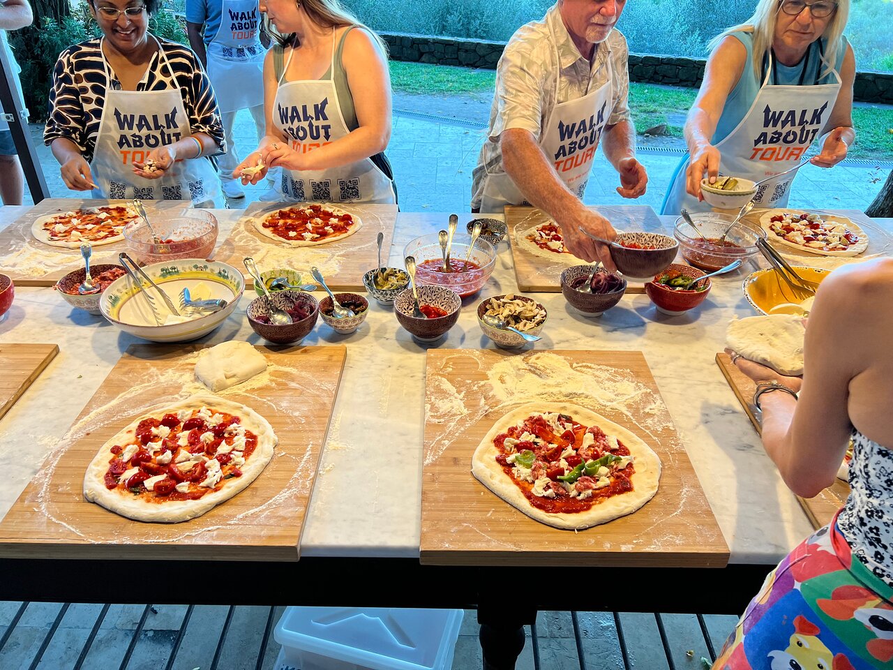 Guests enjoying hands-on pizza-making at Walkabout's cooking class on a Tuscan farm