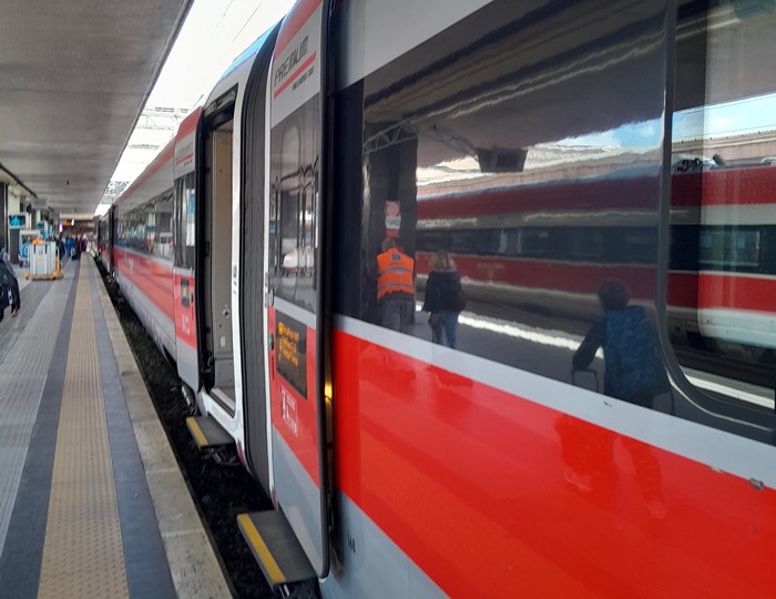 Frecciarossa high-speed train at the platform, easily recognizable by its sleek red design