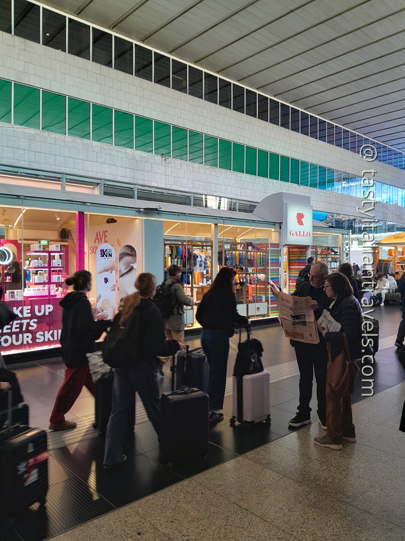 Busy Rome Termini Station with travellers checking signs and making their way to trains before departure