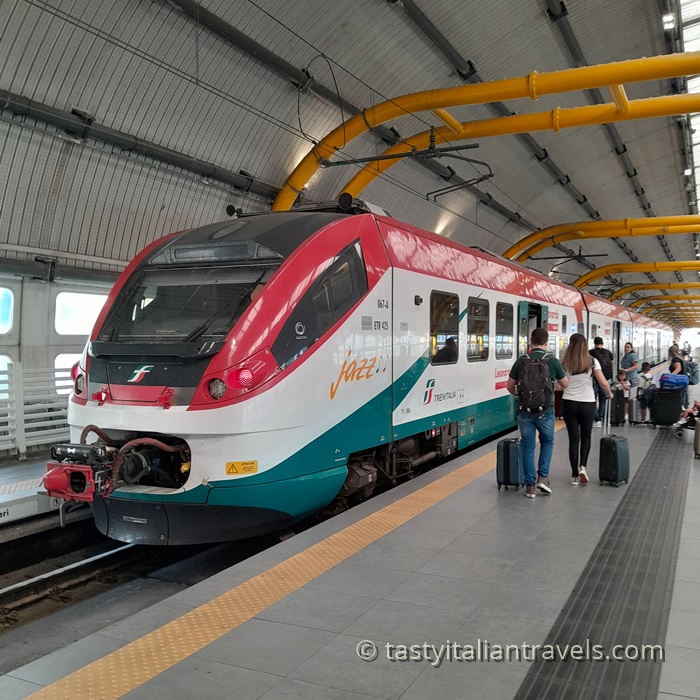 Leonardo Express train at a station platform, providing direct service between Rome Fiumicino Airport and Termini Station in just 32 minutes