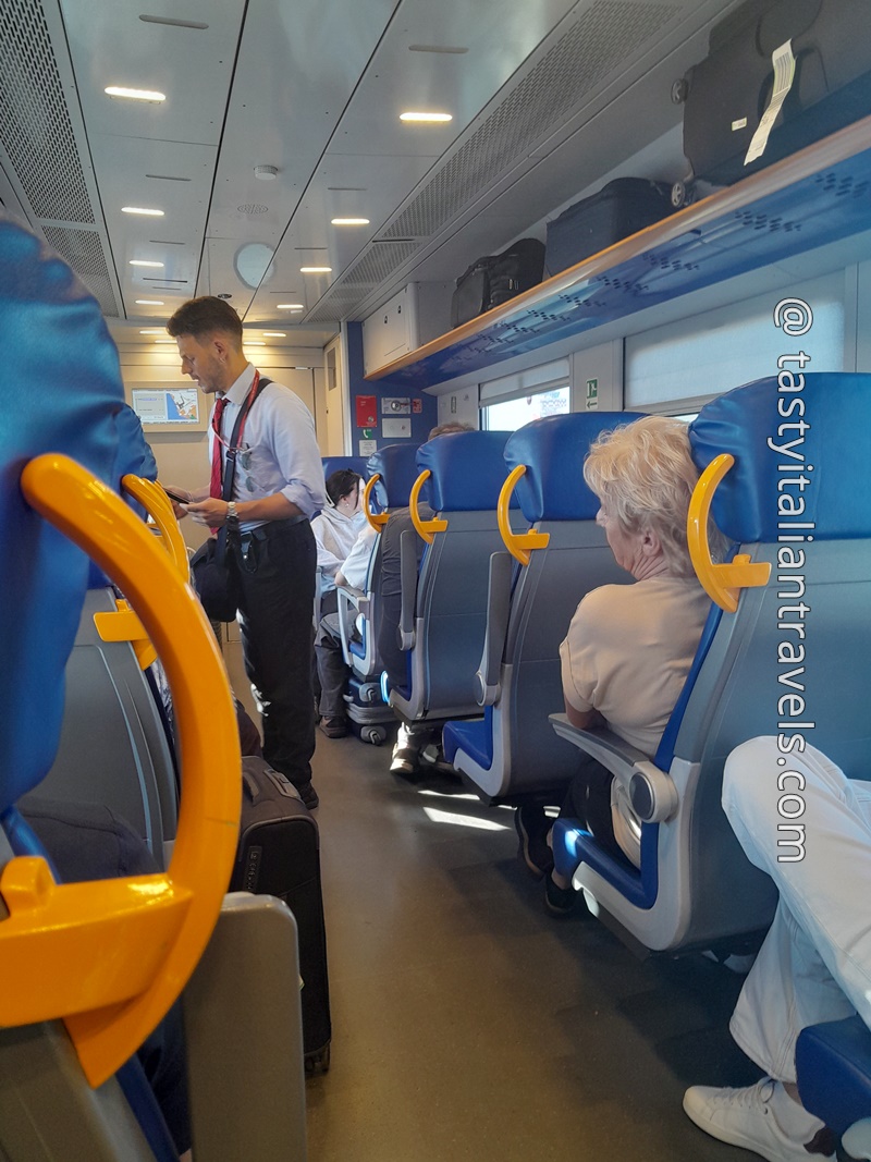 Conductor checking Leonardo Express tickets after departure from Fiumicino Airport
