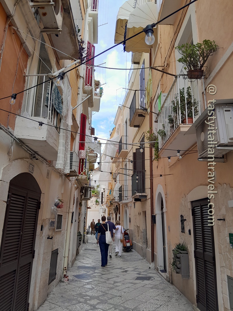 Exploring the narrow stone streets of Bari Vecchia in Bari, Puglia, Italy, on a sunny afternoon