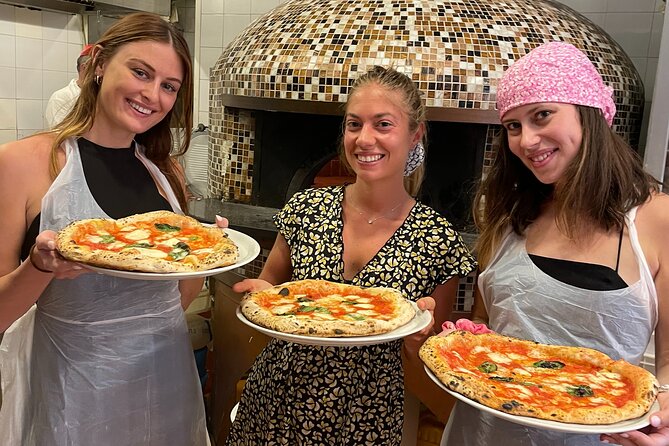 Pizzas freshly baked in a wood-fired oven during a Naples pizza-making class, showcasing golden, bubbly crusts and traditional Neapolitan toppings