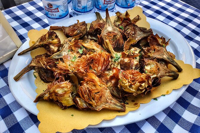 Crunchy fried artichokes, carciofi alla giudia, enjoyed during a nighttime food tour in Rome