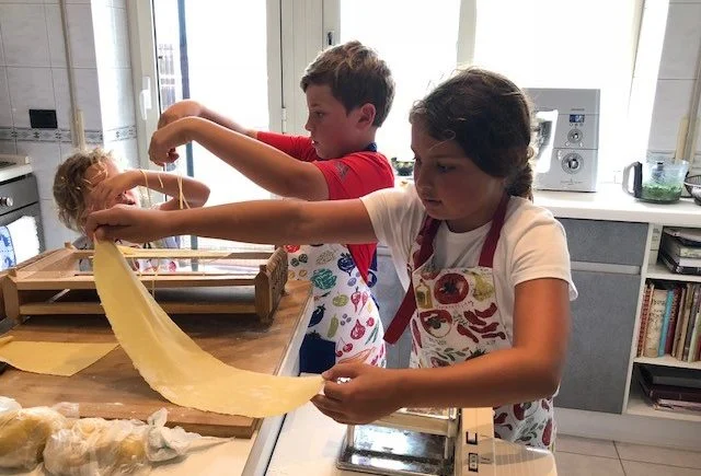Kids learning to make pasta from scratch in a Rome cooking class with Marilee Kids learning to make pasta from scratch in a Rome cooking class with Marilee