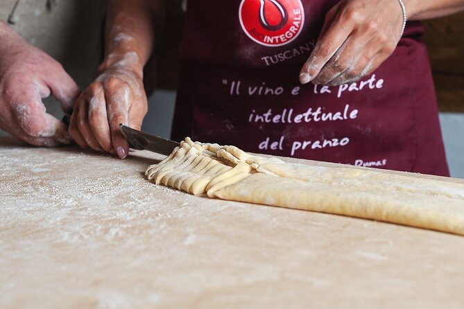 Guests making handmade tagliatelle and tagliolini during a cooking class at a Tuscan castle near Florence
