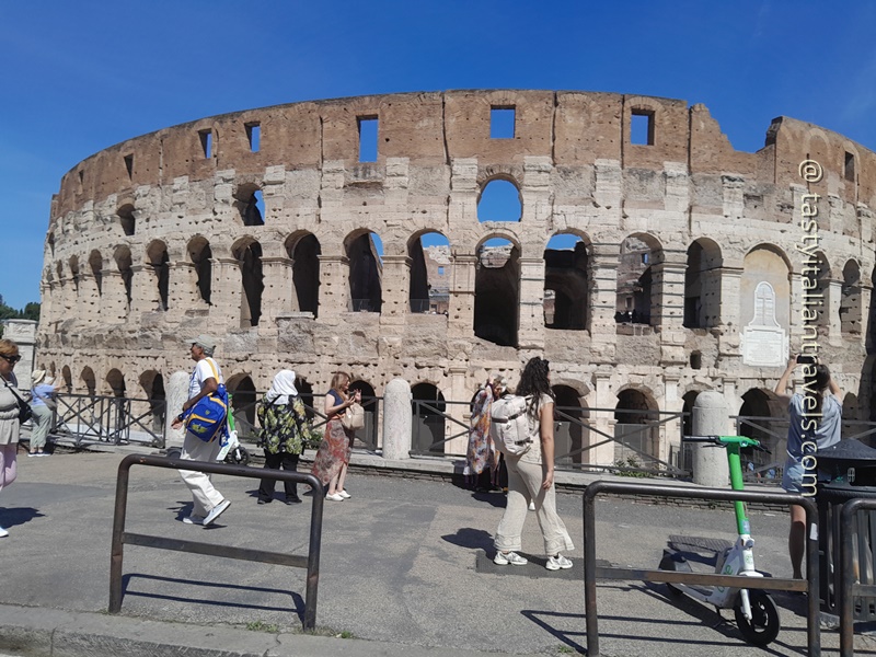 Golf cart tour passing by the Colosseum in Rome with views of the ancient landmark