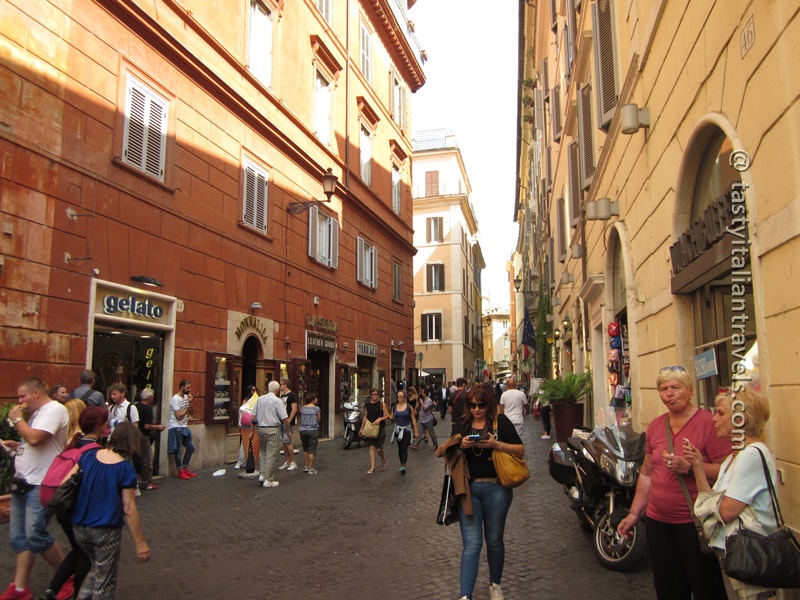 People walking through Rome’s historic center on a summer morning