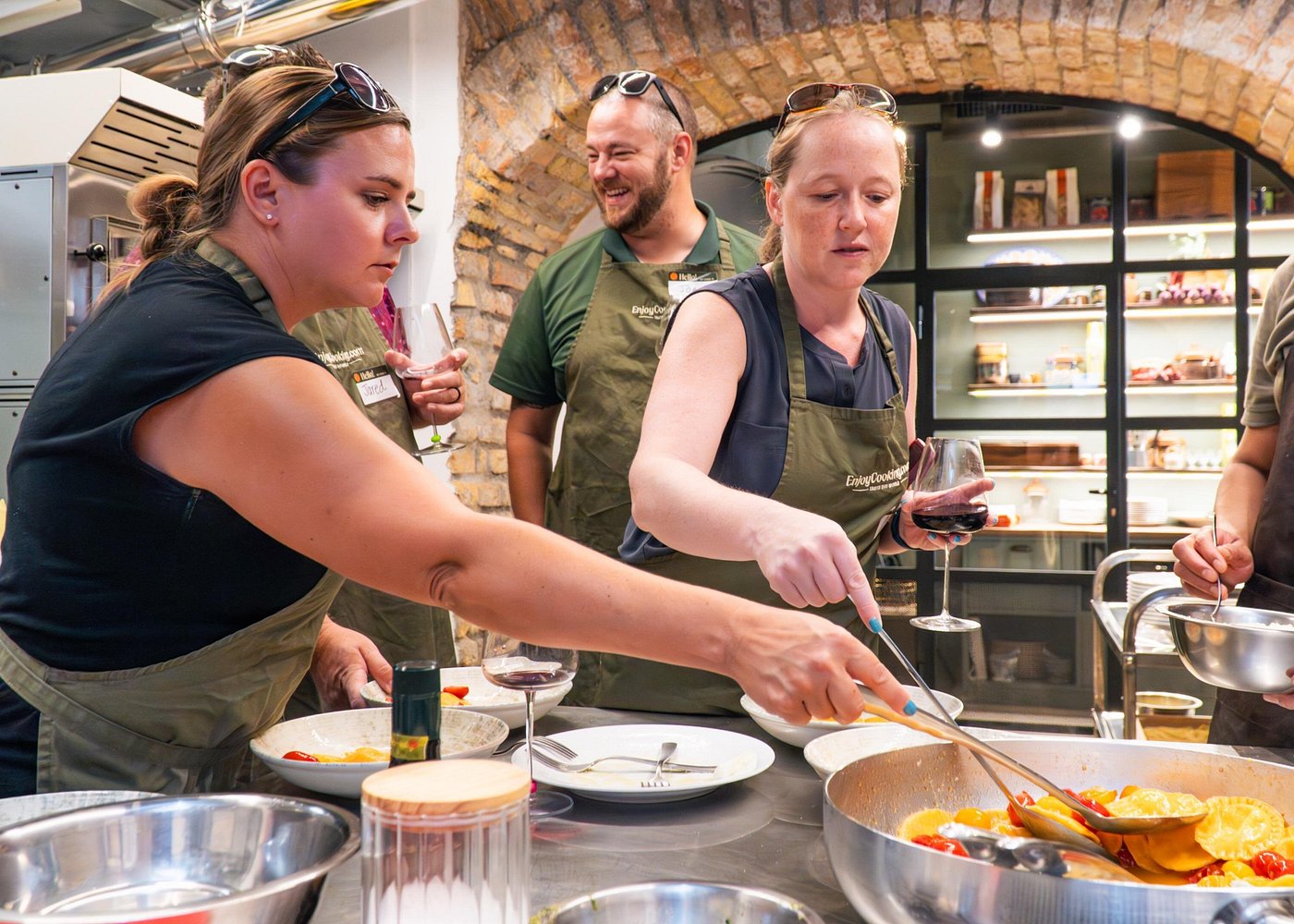 Guests cooking pasta in the sauce at a cooking class near the Colosseum Guests cooking pasta in the sauce during a fun cooking class near the Colosseum