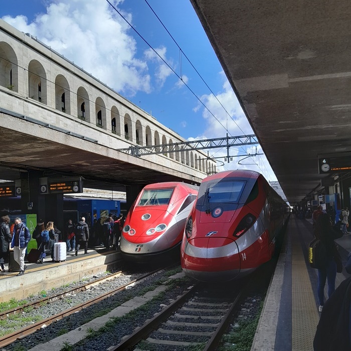 Frecciarossa high-speed train traveling from Rome to Florence on a sunny day