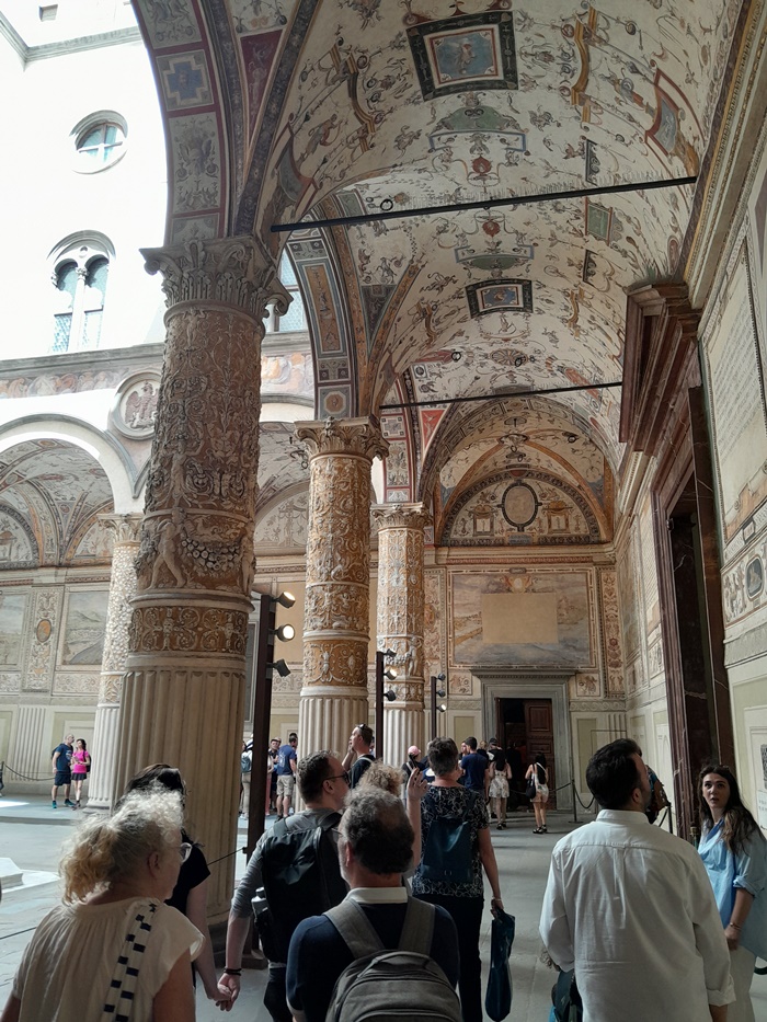 Courtyard of Palazzo Vecchio in Florence, Italy, with Renaissance arches and decorative frescoes