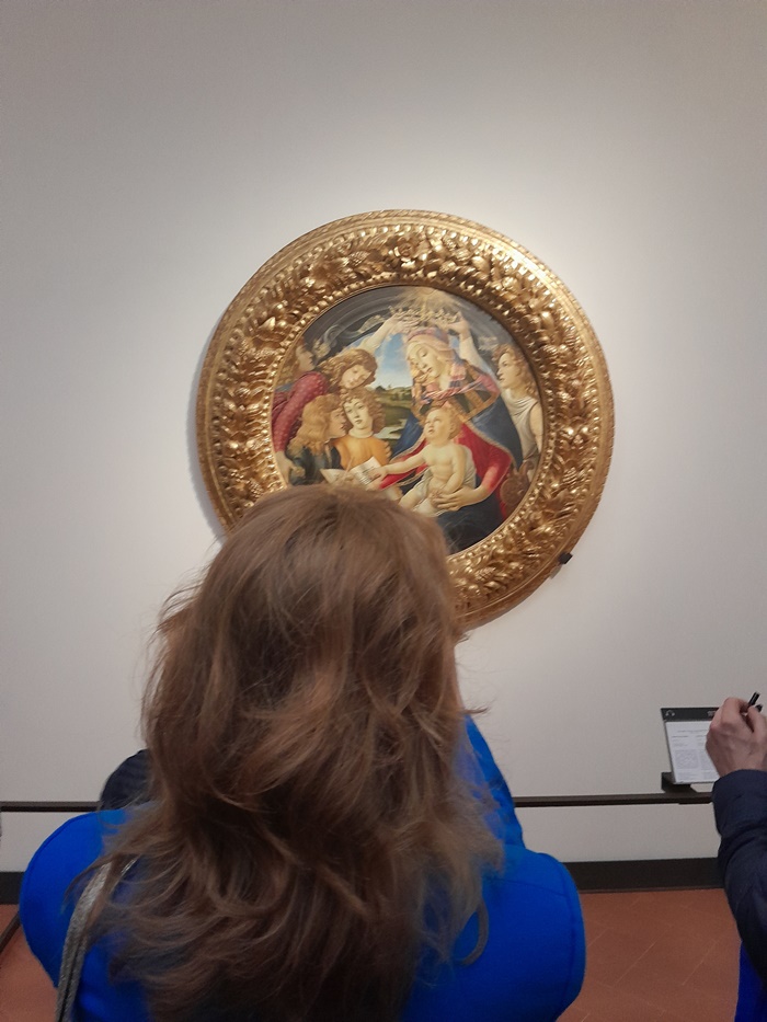 Botticelli’s Madonna of the Magnificat painting in the Uffizi Gallery, depicting the Virgin Mary being crowned by angels while writing in a book