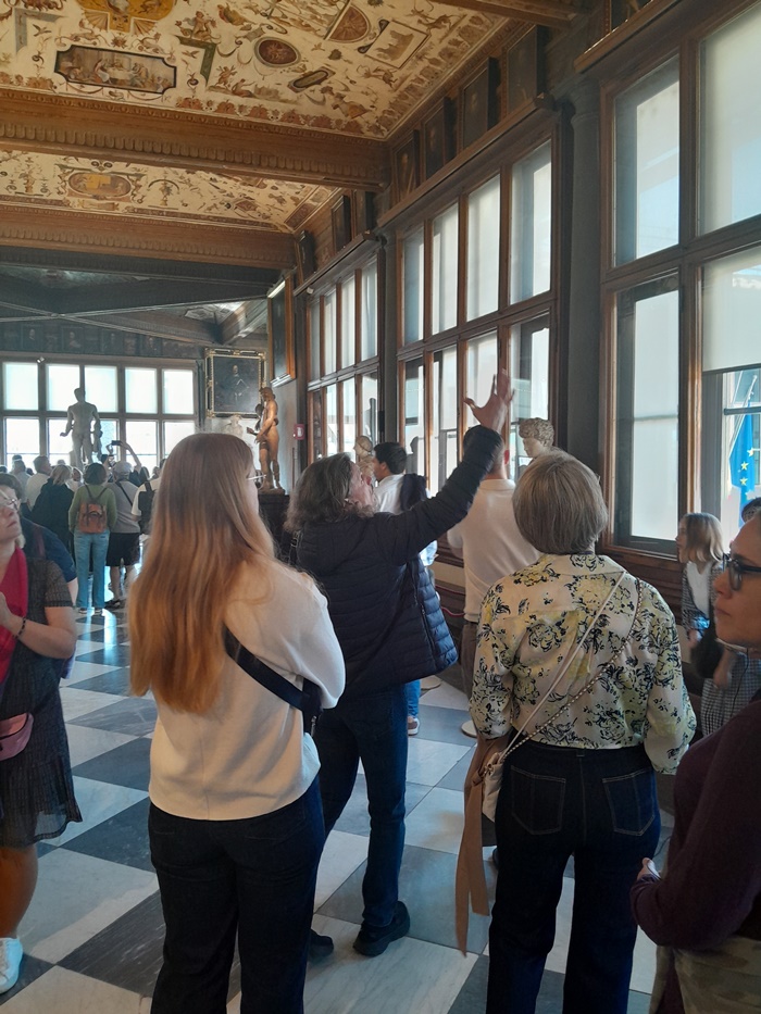 Visitors viewing Renaissance artwork at the Uffizi Gallery in Florence