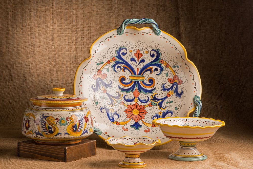 Hand-painted Florentine ceramic plates and bowls on display in a local shop — perfect souvenirs from Florence, Italy