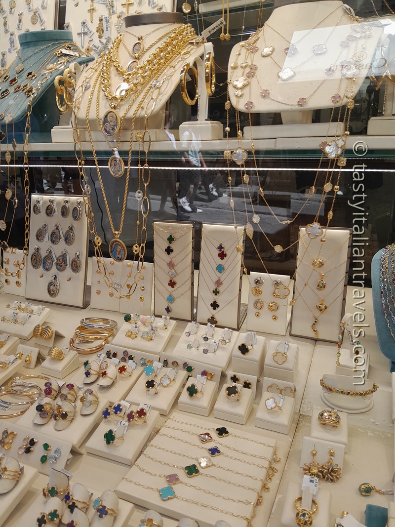 Handcrafted gold jewelry displayed in a Florence jewelry shop, showcasing elegant Italian craftsmanship