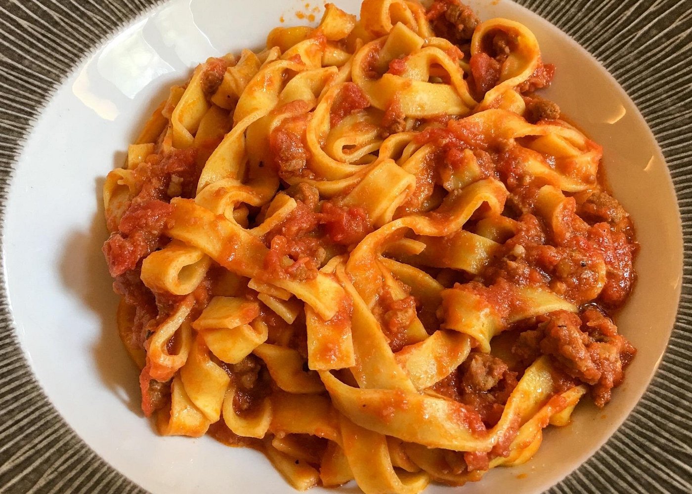 Tagliatelle al ragù, a typical dish from Emilia-Romagna, with fresh pasta noodles covered in rich meat sauce.