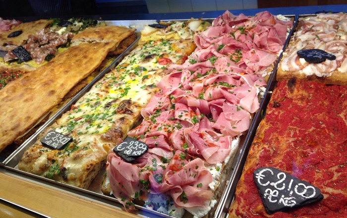 A slice of pizza al taglio from Pizzarium Bonci is a real treat A slice of pizza al taglio from Pizzarium Bonci, topped with fresh ingredients on thick, airy dough