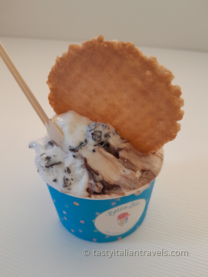 Close-up of a colourful cup filled with creamy gelato from Bella Blue Gelateria, perfect for treating yourself